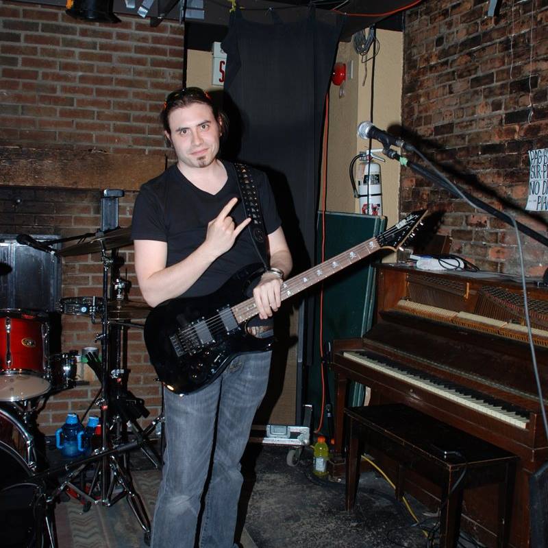 Barber 1 young man with beard smiling and wearing a  brown shirt