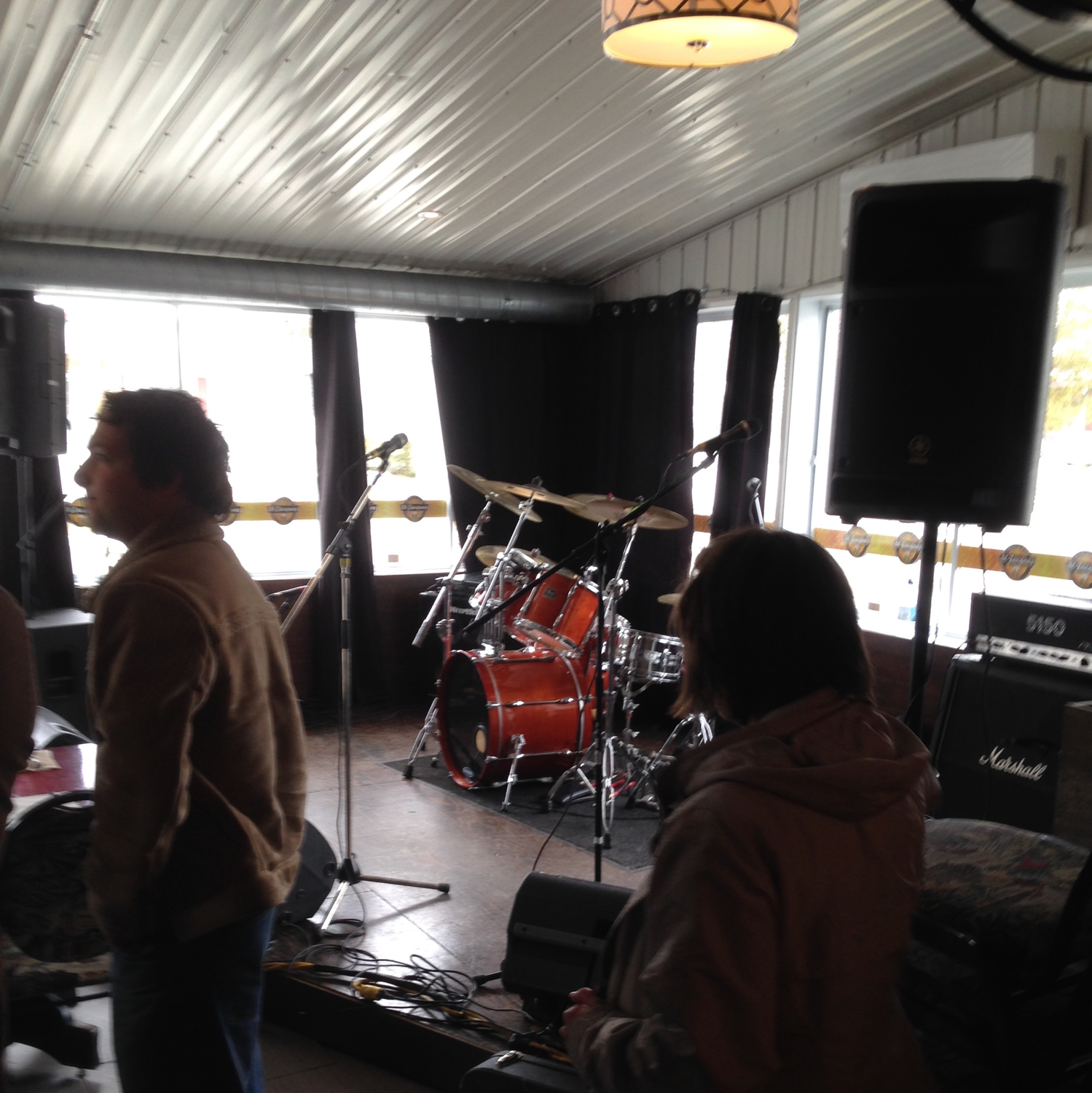 Young man with dark hair and beard, brown eyes, blue t-shirt